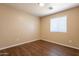 Neutral bedroom with wood-look flooring and bright window at 16021 N 30Th St # 122, Phoenix, AZ 85032