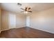 Bedroom featuring wood-look floors, neutral walls, two white doors and natural light from one window at 16021 N 30Th St # 122, Phoenix, AZ 85032