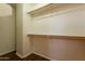 Walk-in closet featuring wood-look floors, white walls and two wooden clothes rods at 16021 N 30Th St # 122, Phoenix, AZ 85032