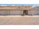 Inviting townhouse exterior with desert landscaping, garage, and covered entryway with block wall construction at 16021 N 30Th St # 122, Phoenix, AZ 85032