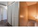 Upstairs hallway with closet and laminate flooring at 16021 N 30Th St # 122, Phoenix, AZ 85032