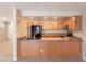 Traditional kitchen featuring wood cabinets, dark countertops, and a black refrigerator at 16021 N 30Th St # 122, Phoenix, AZ 85032
