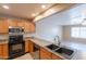 Well-lit kitchen with stainless steel appliances, wood cabinets, double sink, and tile flooring at 16021 N 30Th St # 122, Phoenix, AZ 85032