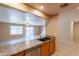 Open concept kitchen with sink and breakfast bar overlooking living space with door to backyard at 16021 N 30Th St # 122, Phoenix, AZ 85032
