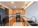 Modern kitchen with stainless steel appliances, tile flooring, wood cabinets, and recessed lighting at 16021 N 30Th St # 122, Phoenix, AZ 85032