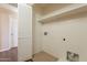 Convenient laundry room with shelving, tile flooring, and utility connections at 16021 N 30Th St # 122, Phoenix, AZ 85032