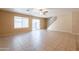 Bright living room featuring tile floors, large windows, and a staircase at 16021 N 30Th St # 122, Phoenix, AZ 85032