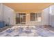 An outdoor covered patio with sliding glass doors leading inside and flagstone flooring at 16021 N 30Th St # 122, Phoenix, AZ 85032