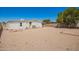 Expansive gravel backyard with white home, privacy fence, and plenty of space for outdoor activities at 16215 N 35Th Way, Phoenix, AZ 85032