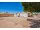 Large backyard featuring a gravel landscape, privacy fence, mature tree, and covered patio at 16215 N 35Th Way, Phoenix, AZ 85032