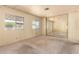 Bedroom featuring neutral carpet, light walls, two windows and mirrored closet doors at 16215 N 35Th Way, Phoenix, AZ 85032