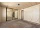 Bedroom featuring neutral carpet, light walls, mirrored closet doors and an adjoining door at 16215 N 35Th Way, Phoenix, AZ 85032