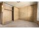 This carpeted bedroom features paneled walls and an open closet at 16215 N 35Th Way, Phoenix, AZ 85032