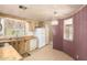 Bright kitchen features wood cabinets, white appliances, and a quaint window over the double sink at 16215 N 35Th Way, Phoenix, AZ 85032