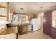 Bright kitchen features wood cabinets, white appliances, and a quaint window over the double sink at 16215 N 35Th Way, Phoenix, AZ 85032