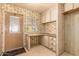 This office area has floral wallpaper and built-in cabinets and drawers at 16215 N 35Th Way, Phoenix, AZ 85032