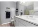 Modern bathroom featuring double sinks, sleek decor, and gray accent walls at 16539 W Winston Dr, Goodyear, AZ 85338