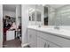 Bright bathroom featuring double vanity, with mirrors and access to closet and luxurious shower at 16539 W Winston Dr, Goodyear, AZ 85338