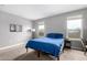 Bedroom featuring carpet, two windows, and a modern lamp at 16539 W Winston Dr, Goodyear, AZ 85338