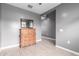 Bedroom featuring wood-look tile floors and a wooden dresser with mirror at 16539 W Winston Dr, Goodyear, AZ 85338