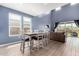 Bright dining area featuring a large window, modern table and chairs, and an open floorplan at 16539 W Winston Dr, Goodyear, AZ 85338