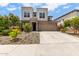 Beautiful two-story home featuring stone accents, a two-car garage, and rock landscaping at 16539 W Winston Dr, Goodyear, AZ 85338