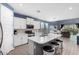 Bright and open kitchen featuring a large island, white cabinets, and modern appliances at 16539 W Winston Dr, Goodyear, AZ 85338
