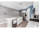 Bright kitchen boasts stainless appliances, stylish countertops and a large island at 16539 W Winston Dr, Goodyear, AZ 85338