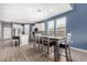 Open kitchen and dining area with white cabinets, an island with seating, and stainless steel appliances at 16539 W Winston Dr, Goodyear, AZ 85338