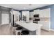 Modern kitchen featuring an island with barstool seating, quartz countertops and stainless appliances at 16539 W Winston Dr, Goodyear, AZ 85338