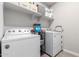 Efficient laundry area equipped with modern washer and dryer, and ample storage shelves at 16539 W Winston Dr, Goodyear, AZ 85338