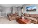 Comfortable living room with neutral colors, bookshelves, and a wooden coffee table at 16539 W Winston Dr, Goodyear, AZ 85338