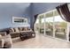Bright living room with a large sliding glass door, stylish furnishings, and a high ceiling at 16539 W Winston Dr, Goodyear, AZ 85338