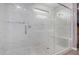 Luxurious shower with frameless glass, bench and marble tile, inviting relaxation at 16539 W Winston Dr, Goodyear, AZ 85338