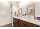 Bathroom featuring double vanity with wood-look tile flooring at 17506 W Hadley St, Goodyear, AZ 85338