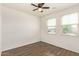 Sunny bedroom with wood-look tile flooring and natural light at 17506 W Hadley St, Goodyear, AZ 85338