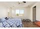 Bright bedroom featuring hardwood flooring and ample natural light at 17506 W Hadley St, Goodyear, AZ 85338