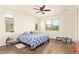 Bright bedroom with wood-look tile flooring, natural light, and multiple windows at 17506 W Hadley St, Goodyear, AZ 85338