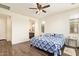 Comfortable bedroom featuring stylish wood-look tile flooring and modern ceiling fan at 17506 W Hadley St, Goodyear, AZ 85338