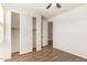 Bright bedroom featuring wood-look flooring and closet with sliding doors at 17506 W Hadley St, Goodyear, AZ 85338
