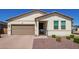 Inviting single-story home featuring a neutral color palette and a well-manicured front yard at 17506 W Hadley St, Goodyear, AZ 85338