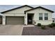 Charming single-story home with desert landscaping, a two-car garage, and a welcoming front porch at 17506 W Hadley St, Goodyear, AZ 85338