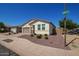 Well-maintained single-story home with neat landscaping and a charming brick driveway at 17506 W Hadley St, Goodyear, AZ 85338