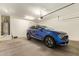 Spacious garage with a blue car, water heater, and ample storage at 17506 W Hadley St, Goodyear, AZ 85338