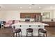 Modern kitchen featuring a large center island with barstool seating and stainless steel appliances at 17506 W Hadley St, Goodyear, AZ 85338