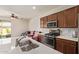 Well-equipped kitchen with stainless steel appliances, countertop island, and access to the outdoor patio at 17506 W Hadley St, Goodyear, AZ 85338