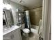 Cozy bathroom featuring a vanity with sink, a shower/tub with a curtain, and tiled walls at 2007 N 55Th Ln, Phoenix, AZ 85035