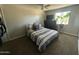 Cozy bedroom with carpet, large window and comfortable bed; a perfect retreat for relaxation and rest at 2007 N 55Th Ln, Phoenix, AZ 85035