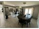 Open-concept dining area flowing into the kitchen with an island bar and stainless steel appliances at 2007 N 55Th Ln, Phoenix, AZ 85035