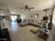 Spacious living room featuring tile flooring, a comfortable sectional sofa, ceiling fan, and a cat tower at 2007 N 55Th Ln, Phoenix, AZ 85035